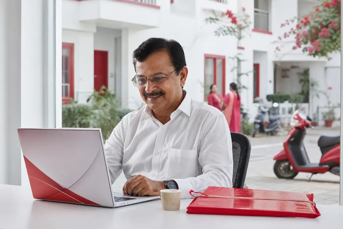 A treasurer smiling at a laptop in the society office
